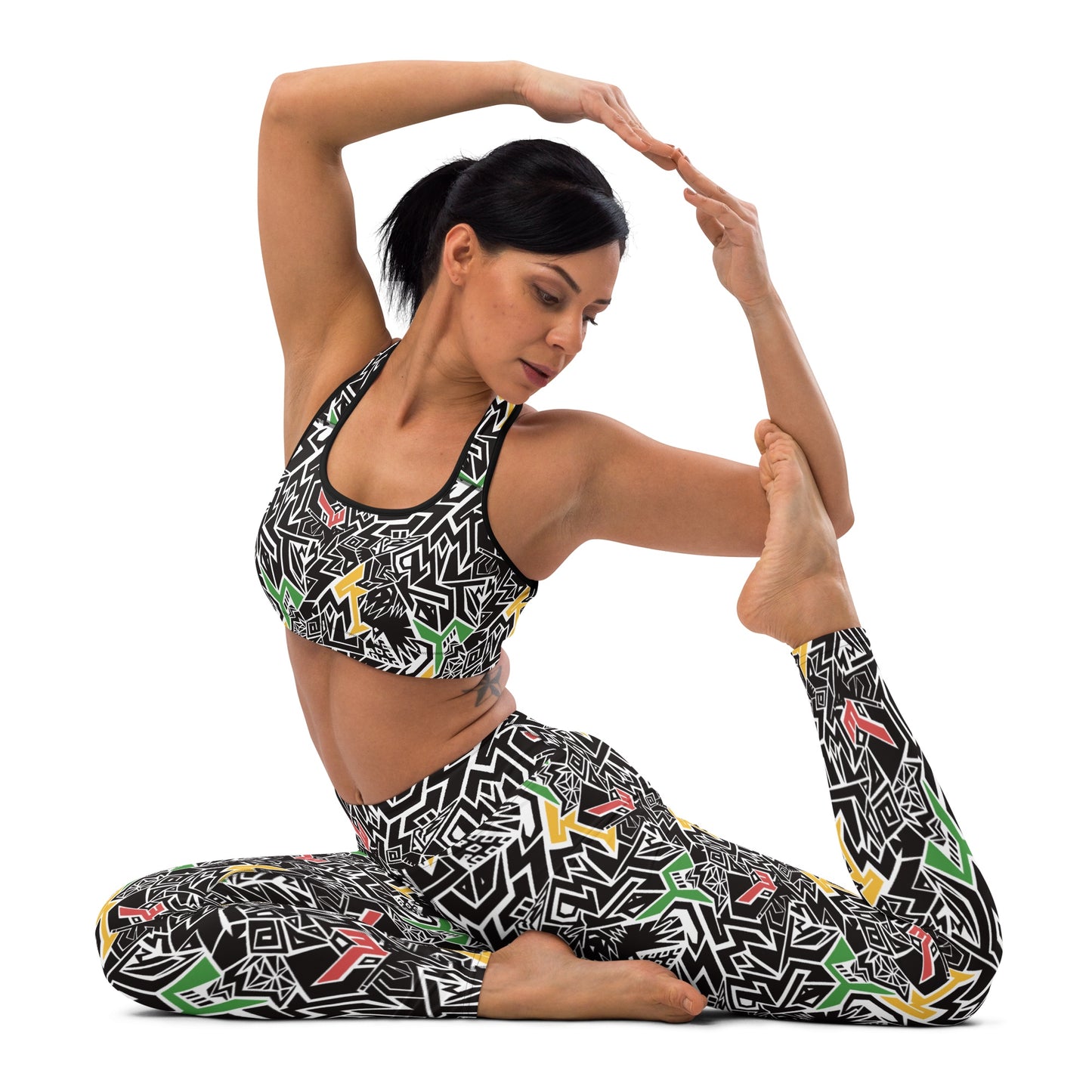 model ing Red, gold, and green patterned leggings and crop top with hidden Smile At Life text, designed by Fowl Plays Print Emporium.