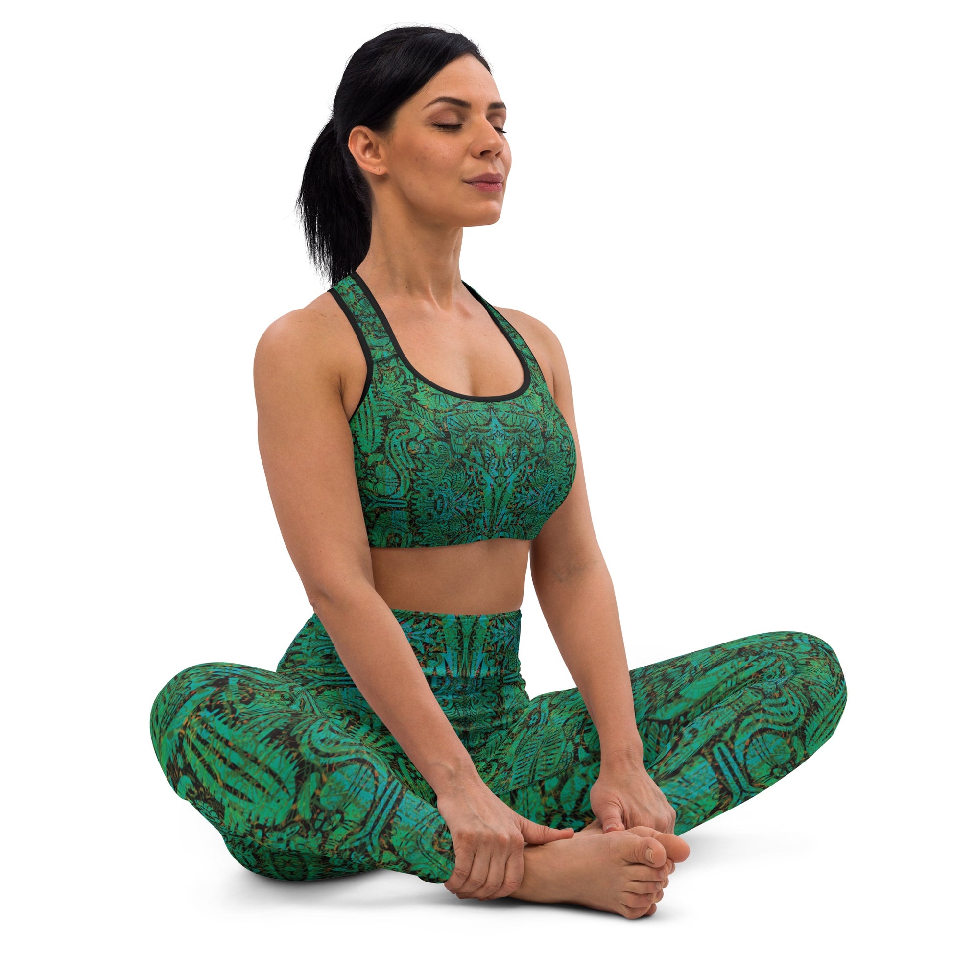 Model wearing turquoise mandala desert leggings and crop top in yoga pose