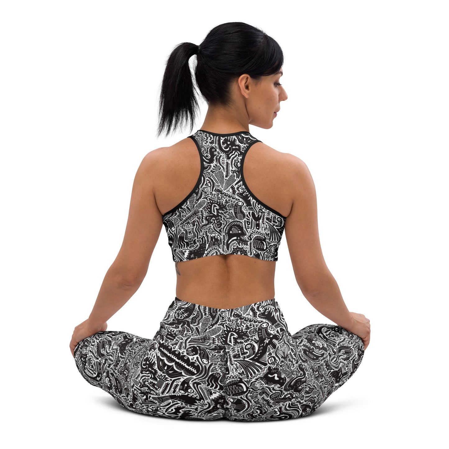 Black and white dinosaur print leggings and crop top on yoga model – Monochrome Edition by Fowl Plays Print Emporium. 