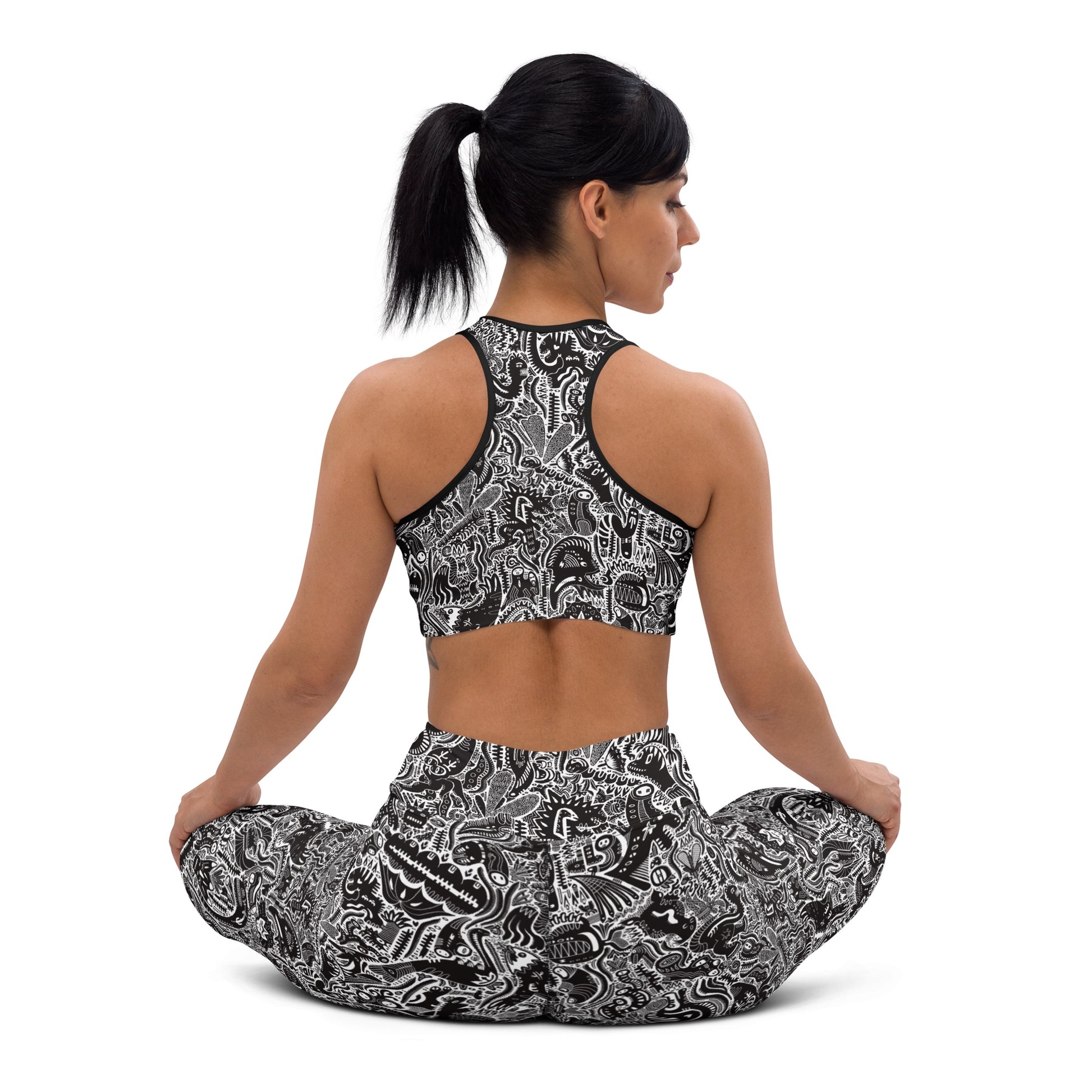 Black and white dinosaur print leggings and crop top on yoga model – Monochrome Edition by Fowl Plays Print Emporium. 