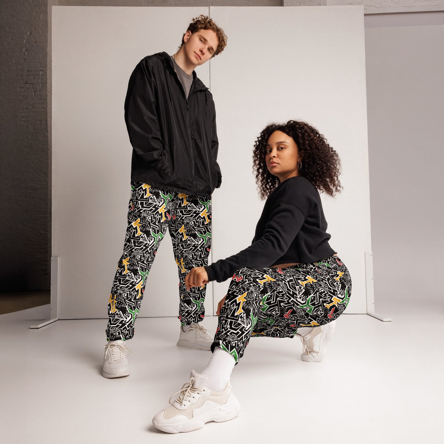 Red, gold, and green Smile At Life Joggers – unisex festival streetwear by Fowl Plays Print Emporium