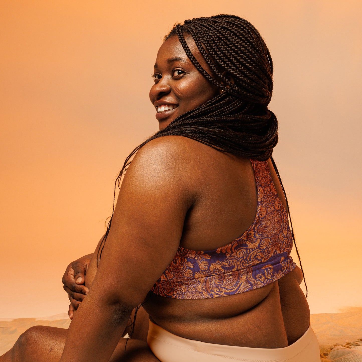 Purple and orange regal design crop top – Royal We Edition by Fowl Plays Print Emporium. back of plus size sports bra