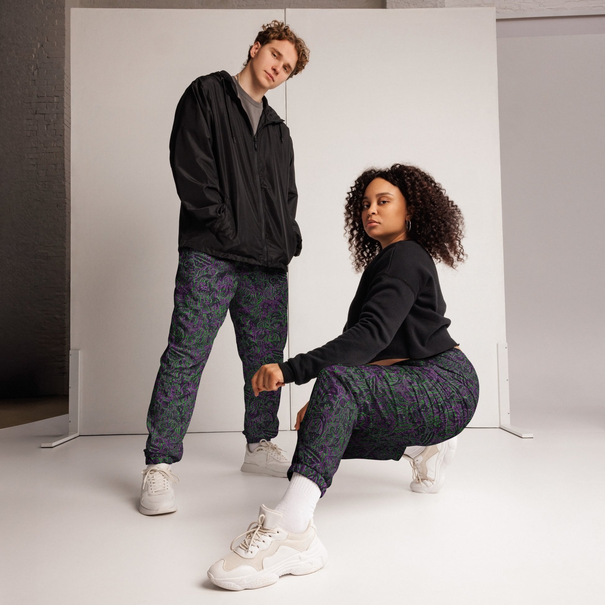 Purple and green dinosaur doodle joggers – Dinosaur Rave Joggers by Fowl Plays Print Emporium