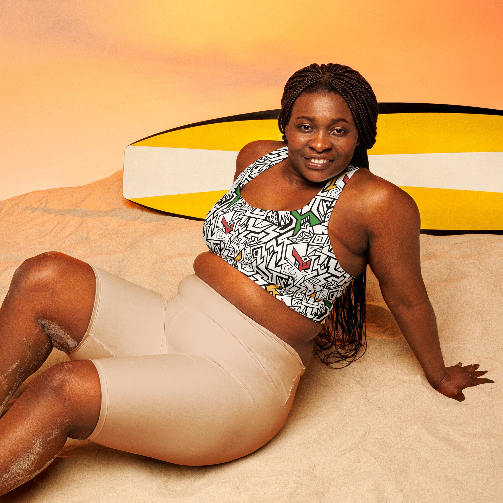 Black, white, red, gold and green psychedelic plus size sports bra with hidden “Smile At Life” message – exclusive sustainable design by Fowl Plays Print Emporium.