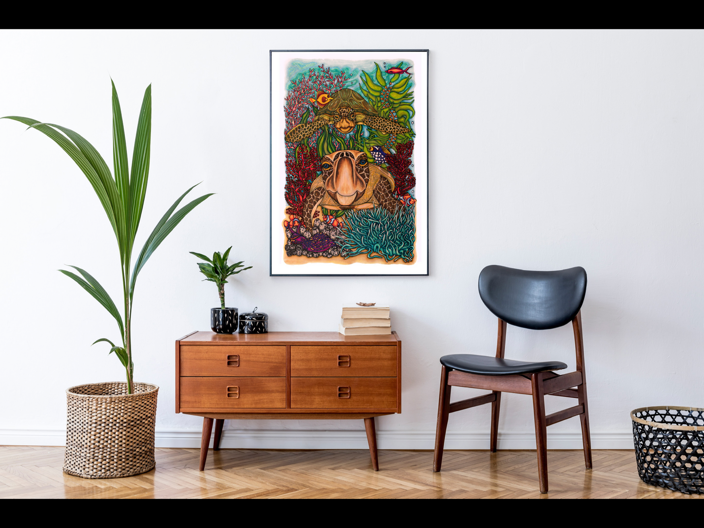 A very colourful ocean coral reef illustration framed and hanging in a faux living room. The image appears to be around A1 in the frame based on the size of the furniture.